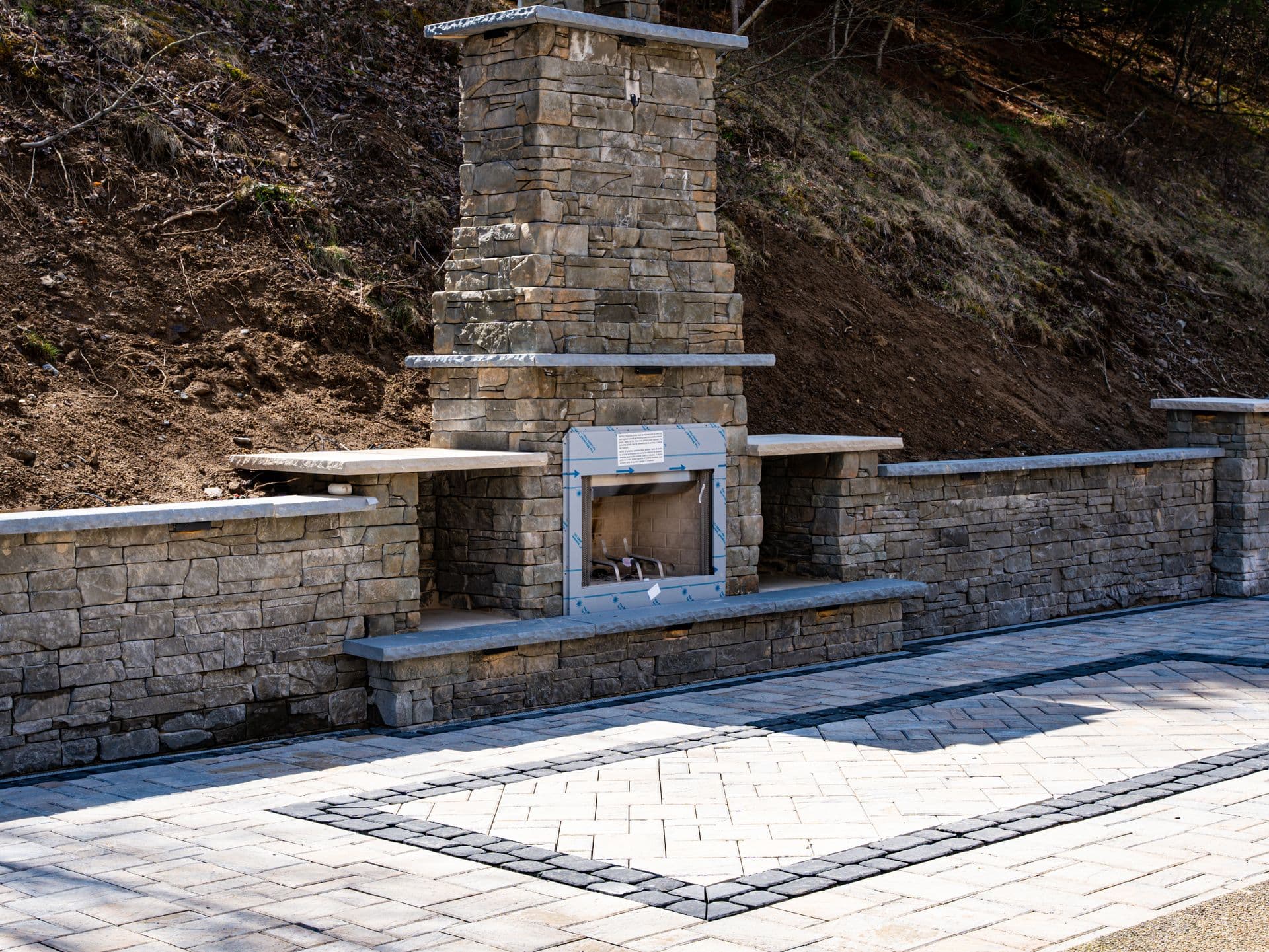 Stone outdoor fireplace with full patio integration in Beaver County