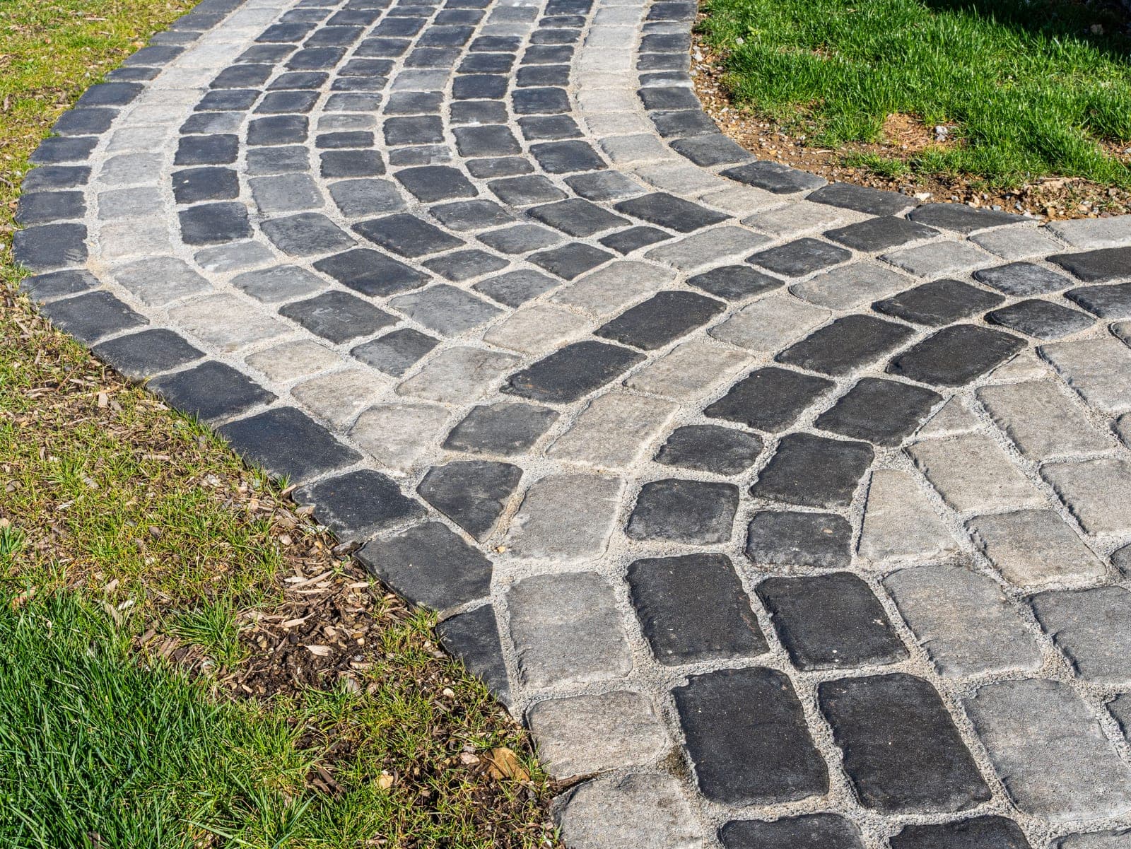curved cobblestone walkway - Elements Landscape Management