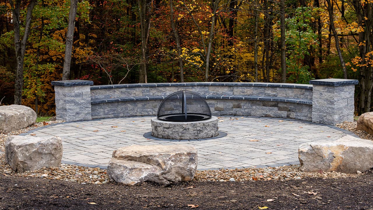 Built-in stone fire pit on a paver patio