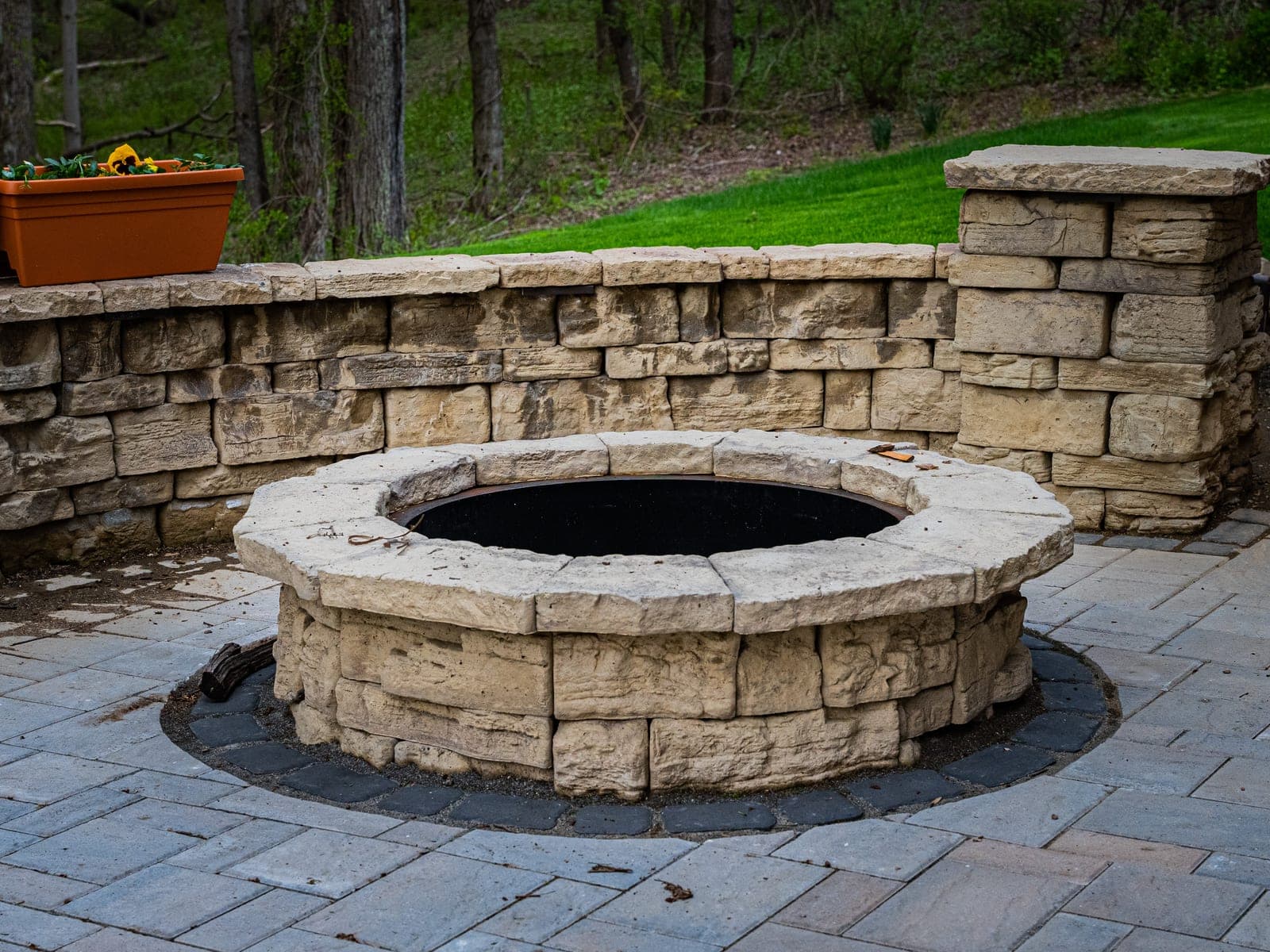 paver patio seat wall daytime - Elements Landscape Management