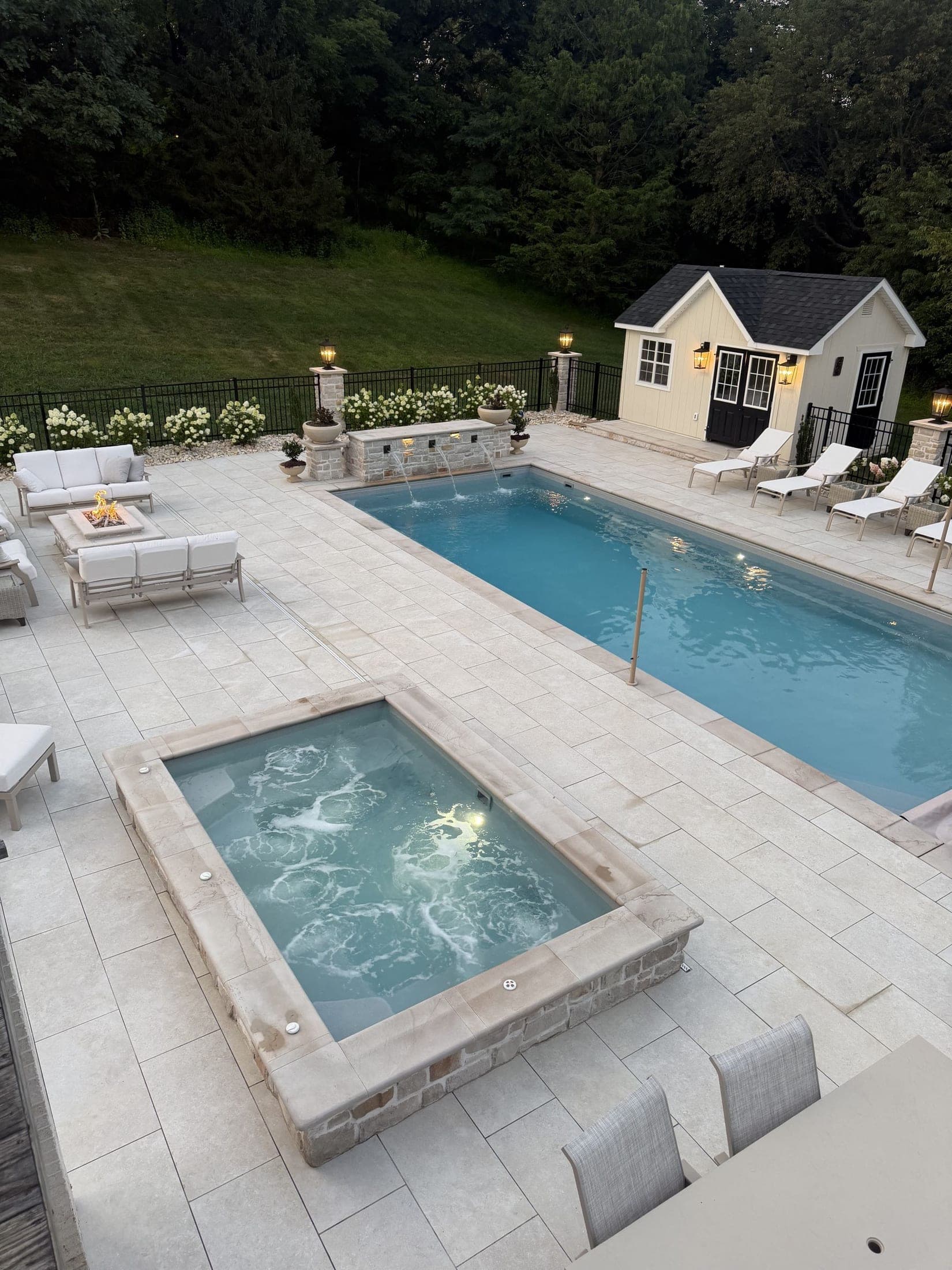 pool spa poolhouse firepit dusk - Elements Landscape Management