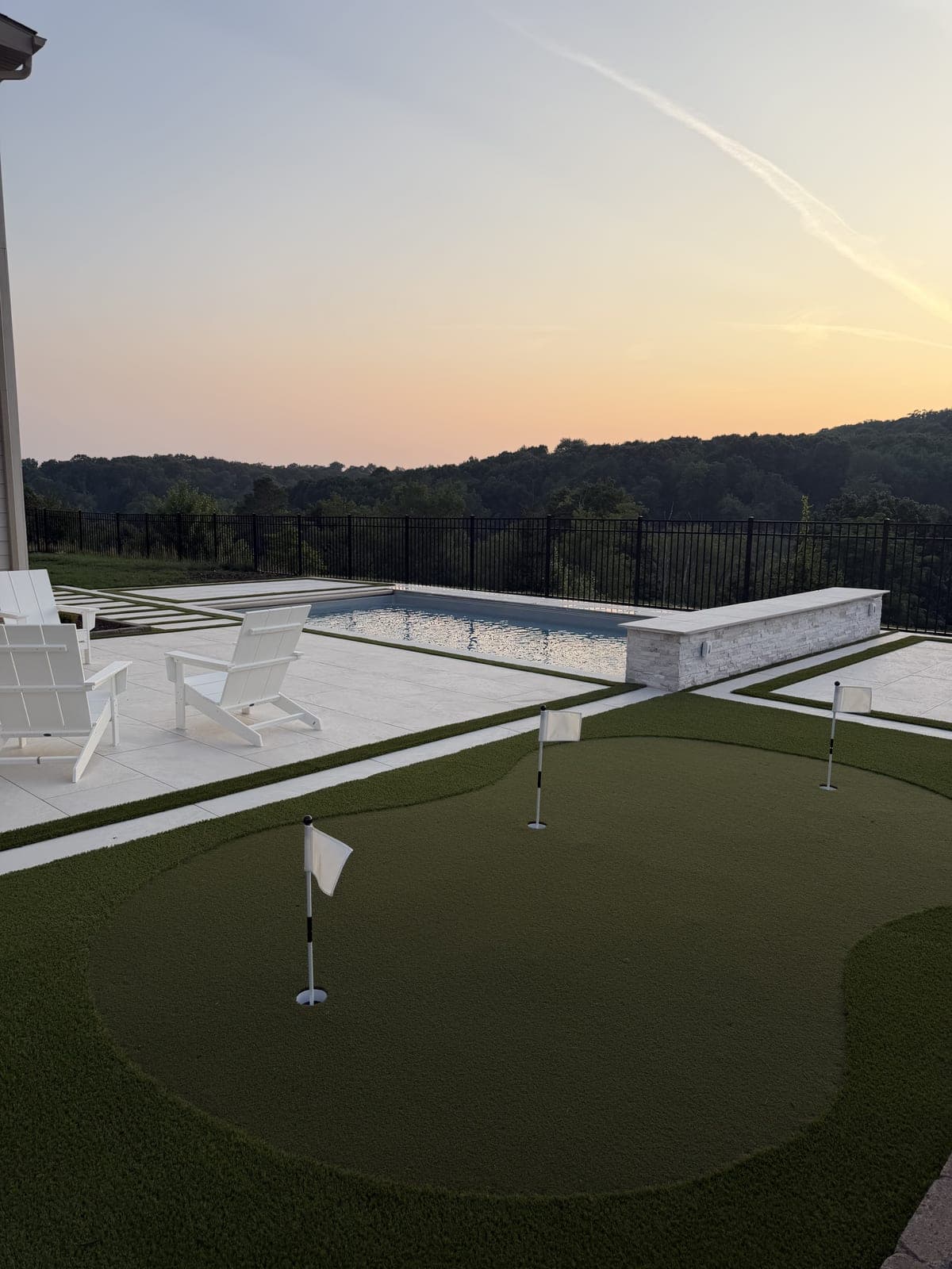Pool and putting green at sunset