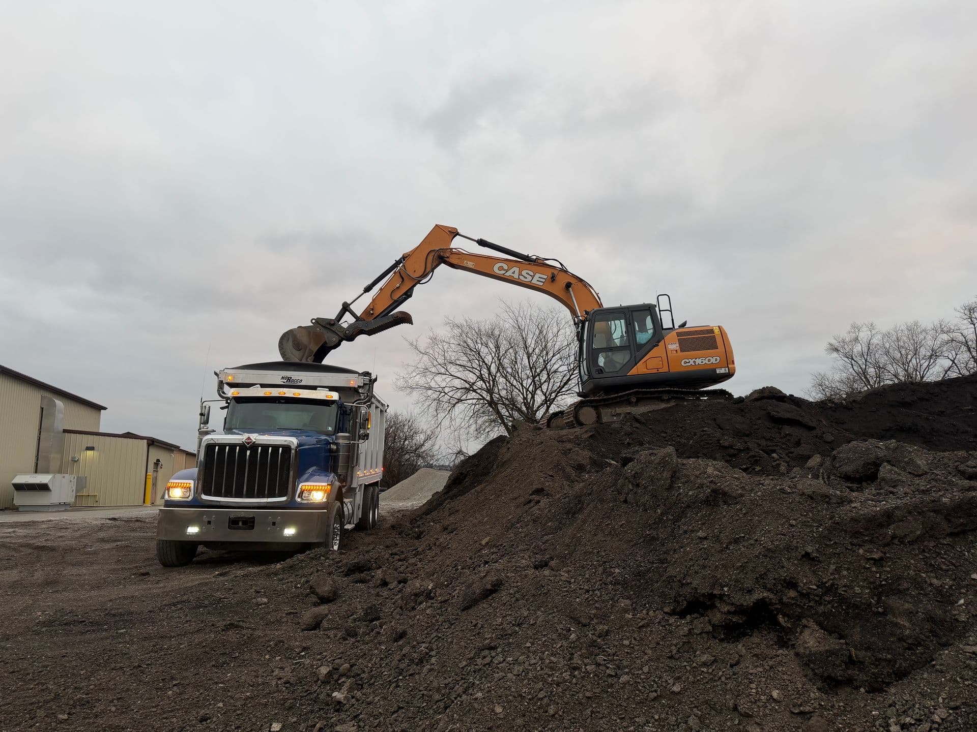 Excavator loading a triaxle dump truck