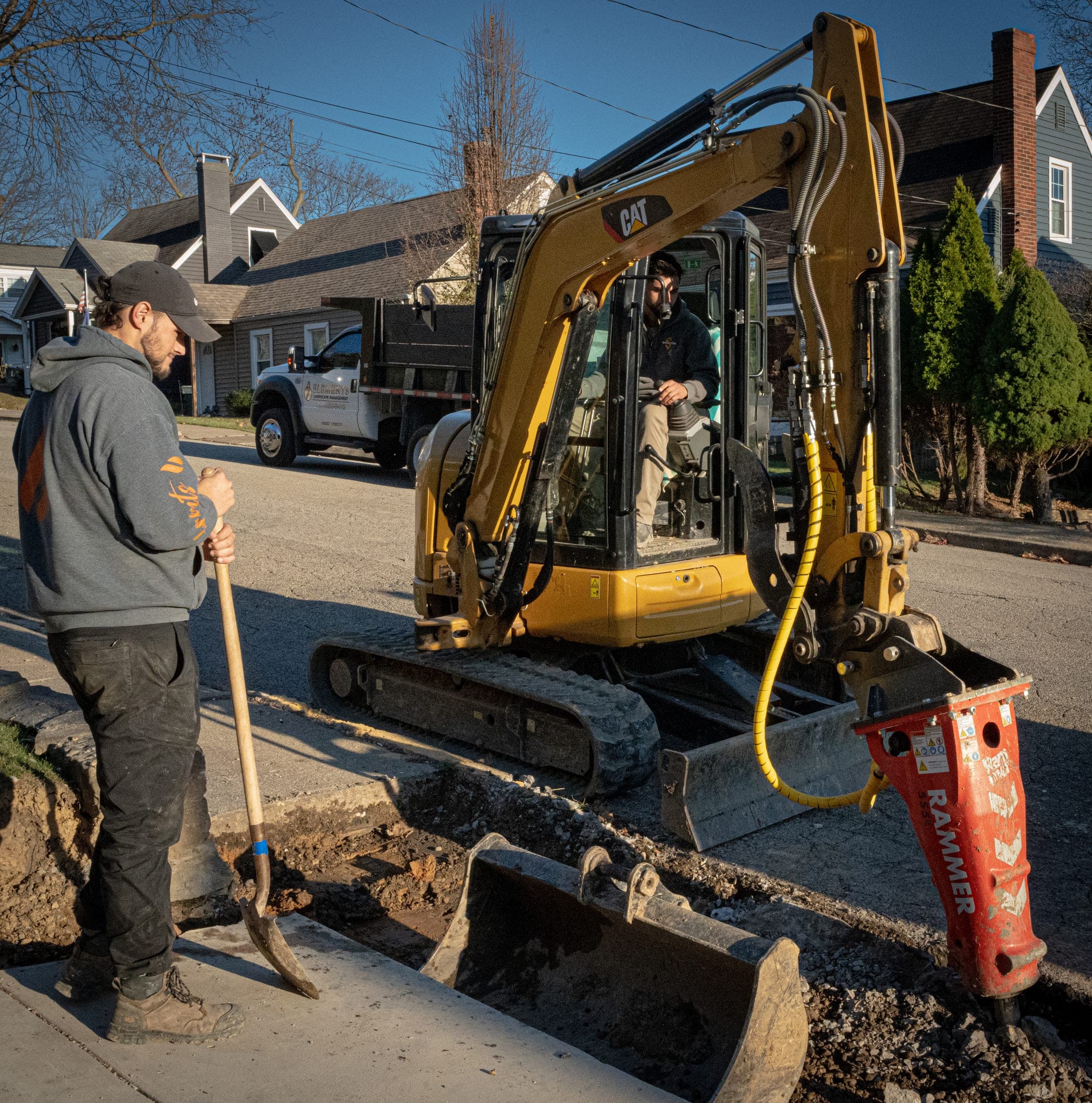 Excavator and truck with crew on a job site