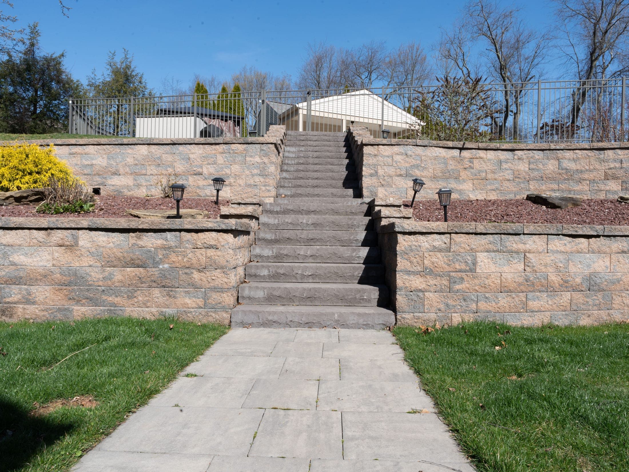 stone staircase tiered wall sky - Elements Landscape Management