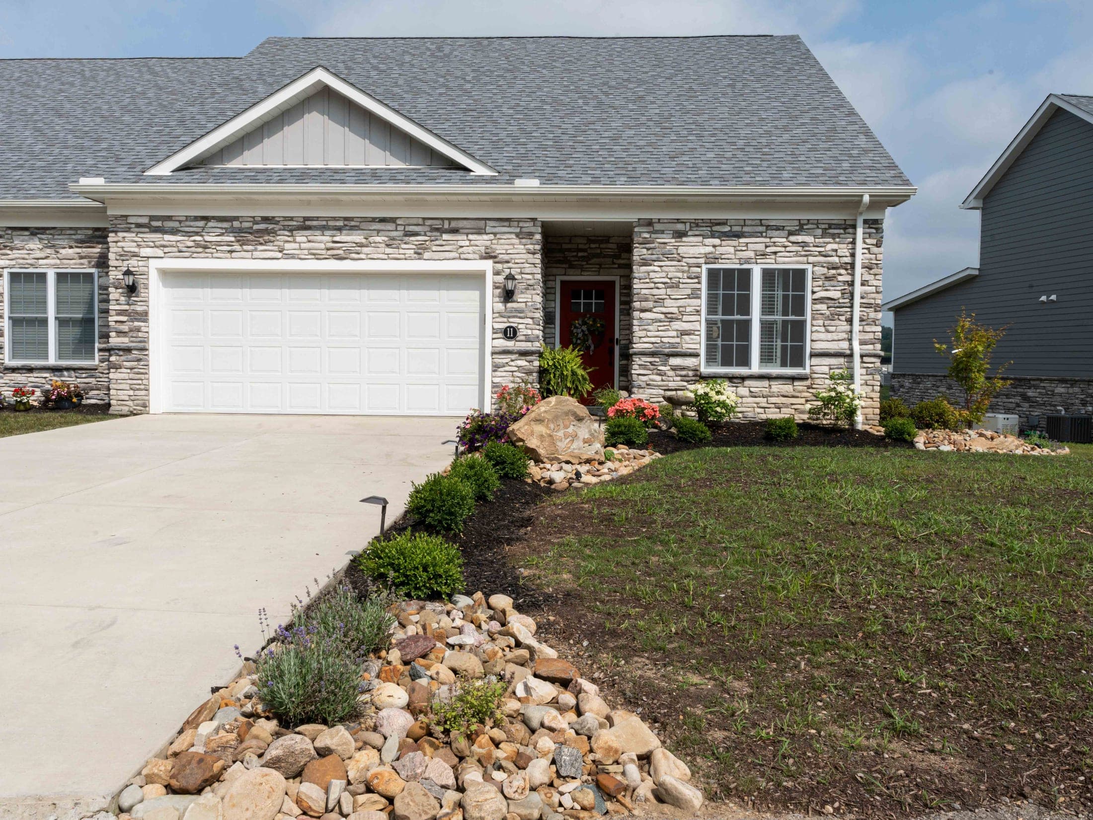 Stone home with boulder-accented foundation planting