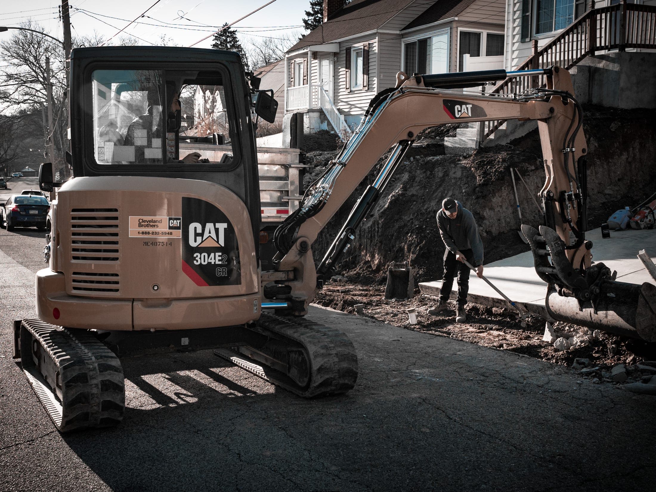 Heavy equipment staged at a retaining wall build