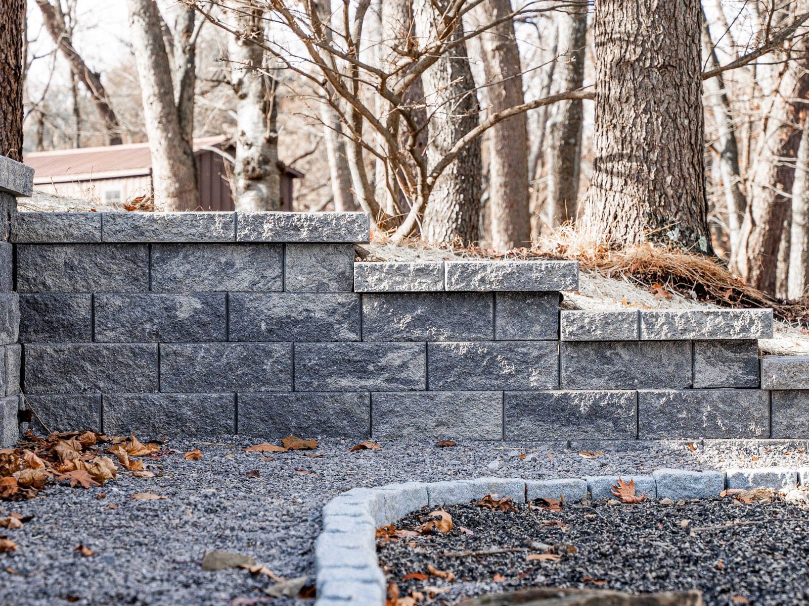 Retaining wall finished with granite curbing