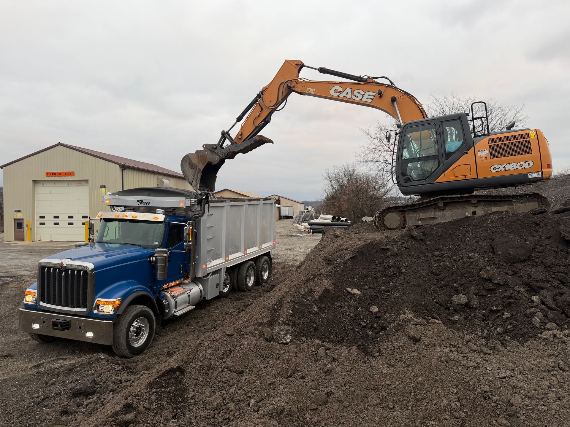 Excavator loading the Elements triaxle dump truck at the material yard